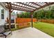 Outdoor space featuring a wooden pergola with a swing, concrete patio, fenced yard, and verdant landscaping at 158 Boots Branch Rd, Summerville, SC 29485