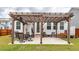 Inviting backyard patio with a pergola, featuring an outdoor dining set and comfortable seating for entertaining at 158 Boots Branch Rd, Summerville, SC 29485