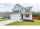 Beautiful two-story home with a welcoming front porch and well-maintained lawn, in a friendly neighborhood at 158 Boots Branch Rd, Summerville, SC 29485