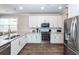 Bright kitchen with white cabinetry, granite countertops, and stainless steel appliances at 158 Boots Branch Rd, Summerville, SC 29485