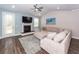 Comfortable living room includes a cozy fireplace, ceiling fan, and plush sectional at 158 Boots Branch Rd, Summerville, SC 29485