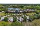 Stunning aerial view of a clubhouse and surrounding landscape, including a pond and ample parking at 160 High Hammock Villas, Seabrook Island, SC 29455