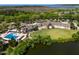Aerial view showing the clubhouse, outdoor pool, parking, and natural surroundings at 160 High Hammock Villas, Seabrook Island, SC 29455