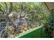 Charming balcony seating with flower pots and overhead foliage at 160 High Hammock Villas, Seabrook Island, SC 29455