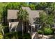Charming condo with traditional architecture surrounded by lush greenery and a stately palm tree at 160 High Hammock Villas, Seabrook Island, SC 29455