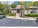 Charming exterior of a condo building with parking spaces and landscaping, offering convenient coastal living at 160 High Hammock Villas, Seabrook Island, SC 29455