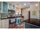 Stylish kitchen with black countertops, stainless steel appliances, and bright blue decorative cabinetry at 160 High Hammock Villas, Seabrook Island, SC 29455