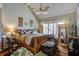 Bright bedroom with vaulted ceiling, ceiling fan, wooden bed frame, and large sliding glass door at 160 High Hammock Villas, Seabrook Island, SC 29455