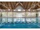 Bright indoor pool area with a wooden vaulted ceiling, white trim, and large windows at 160 High Hammock Villas, Seabrook Island, SC 29455