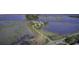 An aerial view shows a residential area with waterfront access and scenic marshland landscape at 1637 Folly Creek Way # E-12, Charleston, SC 29412