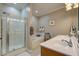 Bathroom featuring double sinks, walk-in shower, soaking tub, and a coastal decor at 1637 Folly Creek Way # E-12, Charleston, SC 29412
