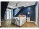 Bright bedroom with hardwood floors, french doors, and a decorative ceiling fan at 1637 Folly Creek Way # E-12, Charleston, SC 29412