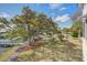 Scenic view of community featuring a lagoon with a walking bridge, fountain, and mature trees at 1637 Folly Creek Way # E-12, Charleston, SC 29412