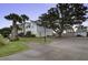 Charming two-story coastal home with a paved driveway, lush landscaping, and mature trees at 1637 Folly Creek Way # E-12, Charleston, SC 29412