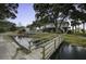 Exterior view features a home, bridge, pond, and an outdoor swimming pool, providing a serene landscape at 1637 Folly Creek Way # E-12, Charleston, SC 29412