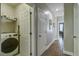 Bright hallway with hardwood floors and access to a laundry room with washer and dryer at 1637 Folly Creek Way # E-12, Charleston, SC 29412