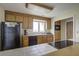 Well-lit kitchen features wood cabinets, black appliances, and a window view of the outdoors at 1637 Folly Creek Way # E-12, Charleston, SC 29412