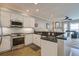 Modern kitchen featuring granite counters, stainless appliances, and white cabinets at 1637 Folly Creek Way # E-12, Charleston, SC 29412