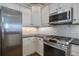 Well-equipped kitchen boasts stainless steel appliances, white cabinets, and granite countertops at 1637 Folly Creek Way # E-12, Charleston, SC 29412