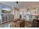 Open floor plan connecting the living room, dining area, and kitchen with light wood flooring at 1637 Folly Creek Way # E-12, Charleston, SC 29412