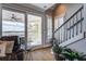 Inviting living room with access to balcony with water views and staircase to second level at 1637 Folly Creek Way # E-12, Charleston, SC 29412