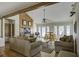 Bright living room with high ceilings, wood beams, and comfortable seating for relaxing and entertaining at 1637 Folly Creek Way # E-12, Charleston, SC 29412