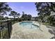 Outdoor swimming pool features lounge chairs, pool house, and fenced-in area for recreation and relaxation at 1637 Folly Creek Way # E-12, Charleston, SC 29412