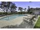 Outdoor swimming pool with lounge chairs and a tranquil fenced-in setting for recreation and relaxation at 1637 Folly Creek Way # E-12, Charleston, SC 29412