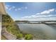 Tranquil water view showcasing a pier, covered boat dock, and surrounding greenery at 1637 Folly Creek Way # E-12, Charleston, SC 29412