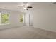 Large bedroom featuring two windows, neutral carpet, and a ceiling fan for added comfort at 168 Keaton Brook Dr, Summerville, SC 29485