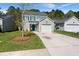 Charming two-story home with a well-manicured lawn, attached garage, and a bright blue front door at 168 Keaton Brook Dr, Summerville, SC 29485