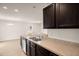 Kitchen with stainless steel appliances, dark cabinets, light counter tops and open to the dining area at 168 Keaton Brook Dr, Summerville, SC 29485
