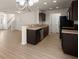 Modern kitchen with hardwood floors, stainless steel appliances, and dark wood cabinets at 168 Keaton Brook Dr, Summerville, SC 29485