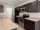 Modern kitchen with stainless steel appliances, dark cabinets, and light countertops at 168 Keaton Brook Dr, Summerville, SC 29485