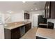 Open kitchen with stainless steel dishwasher, dark wood cabinets, and light countertops at 168 Keaton Brook Dr, Summerville, SC 29485