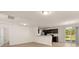 Open-concept living room showcasing modern kitchen with stainless steel appliances and sliding door to backyard at 168 Keaton Brook Dr, Summerville, SC 29485
