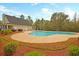 Sparkling community pool surrounded by lush landscaping and comfortable lounge chairs at 168 Keaton Brook Dr, Summerville, SC 29485