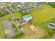 Enjoy this aerial view of the neighborhood pool and playground, alongside a pond and mature trees at 1728 Refuge Dr, Ladson, SC 29456