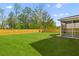 A large backyard featuring green grass, a swing set and a screened porch at 1728 Refuge Dr, Ladson, SC 29456