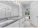 Bright bathroom featuring a double granite vanity, tiled floors, and an open doorway to the main bedroom at 1728 Refuge Dr, Ladson, SC 29456