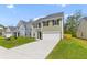 Beautiful two-story home on a green lawn with a concrete driveway at 1728 Refuge Dr, Ladson, SC 29456
