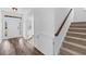 Bright foyer with hardwood floors, staircase, and white trim detail throughout at 1728 Refuge Dr, Ladson, SC 29456