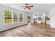 Open-concept living room featuring hardwood floors and a bright kitchen at 1728 Refuge Dr, Ladson, SC 29456