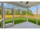 Screened porch offers backyard views of the green grass and fenced yard at 1728 Refuge Dr, Ladson, SC 29456