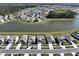 A scenic aerial view of a neighborhood, showcasing houses surrounding a lake and wooded area at 183 Greenwich Dr, Summerville, SC 29486