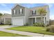 Charming two-story home with a two-car garage and a well-manicured lawn in front at 183 Greenwich Dr, Summerville, SC 29486