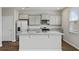 A kitchen island with granite counters complements stainless steel appliances and light gray cabinets at 183 Greenwich Dr, Summerville, SC 29486