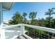 Enjoy the view from this balcony, showcasing beautiful greenery, trees, and a clear blue sky at 1905 Lone Oak Pt, Mount Pleasant, SC 29466