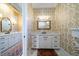 Open view of two vanities with white cabinets, marble counters, and striking wallpaper at 1905 Lone Oak Pt, Mount Pleasant, SC 29466