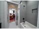 Elegant bathroom showcasing a tub with gray subway tiles, and white penny tile flooring leading into the bedroom at 1905 Lone Oak Pt, Mount Pleasant, SC 29466
